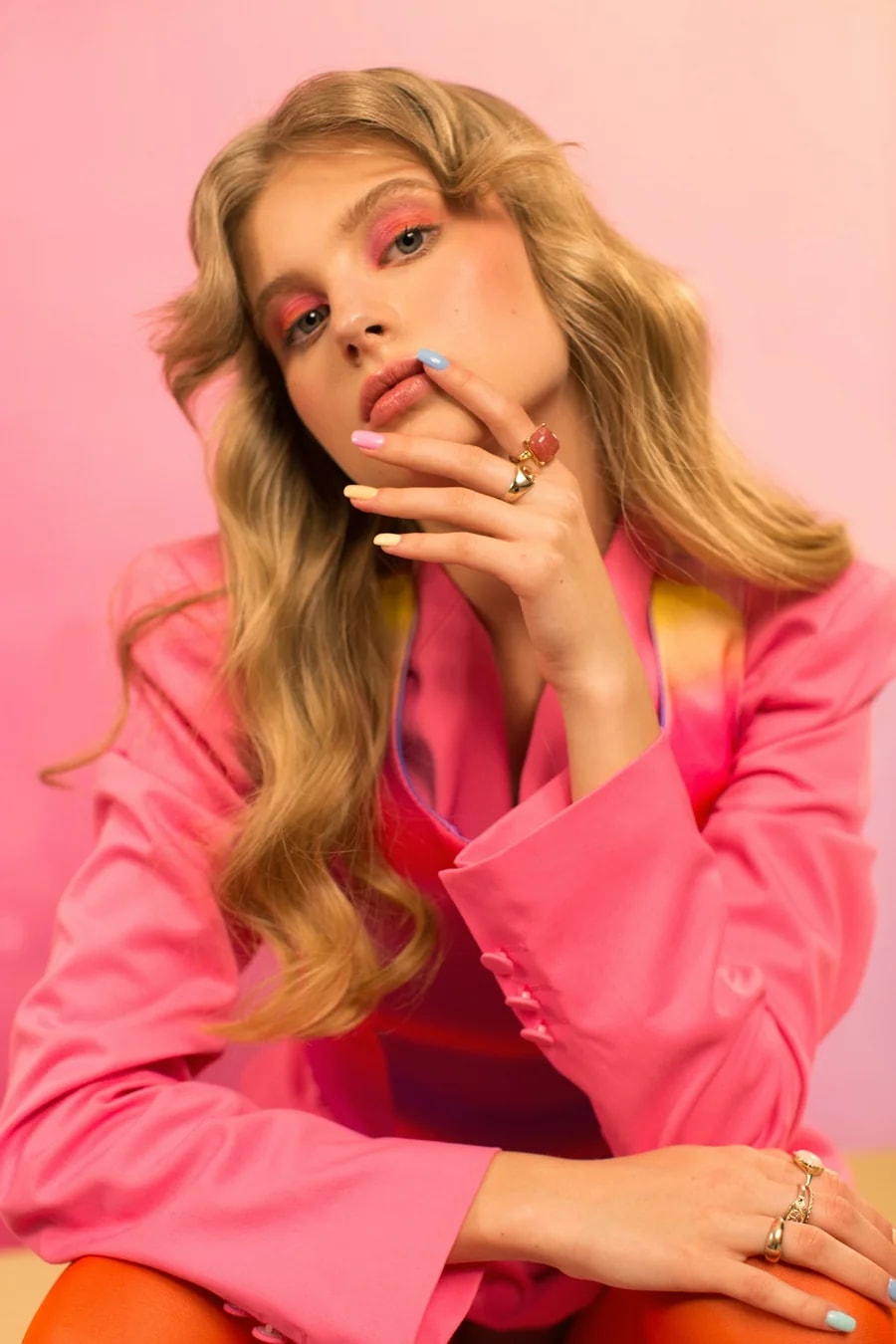 Model in a pink blazer with pastel nails